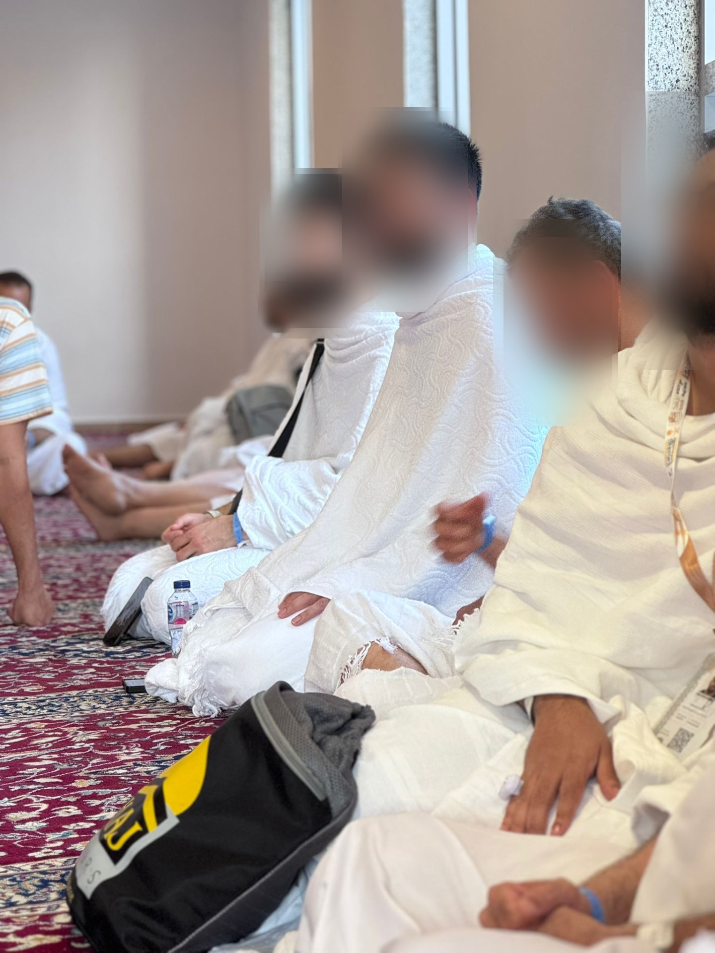 Pilgrims in ihram sitting in reflection