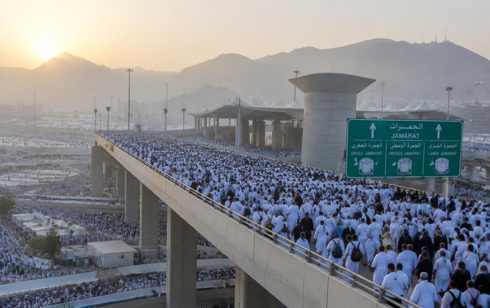 Pilgrims crossing the Jamarat bridge at dawn